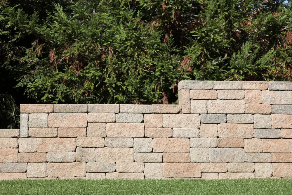 Stacked concrete block retaining wall in a landscaped yard Hickory NC — The Foothills Concrete Company