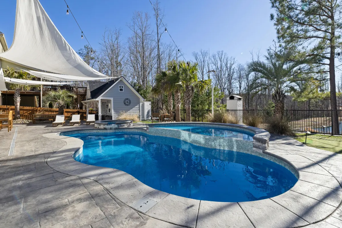 Stamped concrete pool deck around freeform pool NC Foothills — The Foothills Concrete Company
